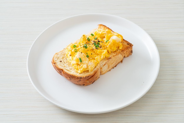 bread toast with scramble egg on white plate