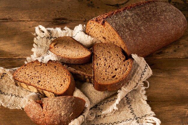 Bread traditional homemade bread cut into slices on a rustic wooden background closeup