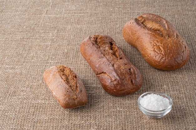 Bread traditional sourdough bread on a background of burlap The concept of traditional ways of ba