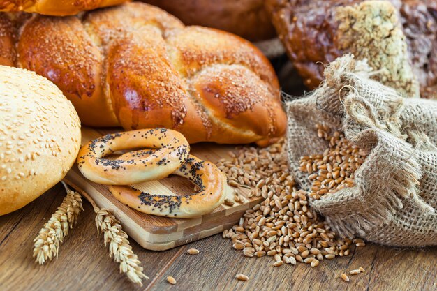 Bread and wheat on a wooden background