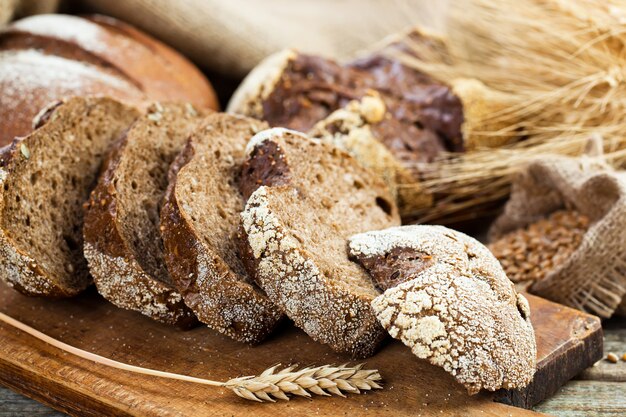 Bread and wheat on a wooden background