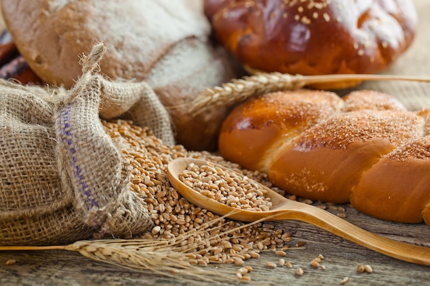 Bread and wheat on a wooden background