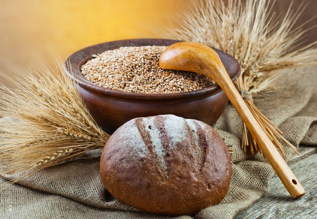 Bread and wheat on a wooden board