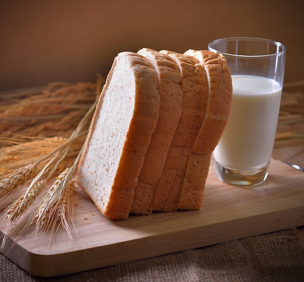 Bread and wheat on the wooden