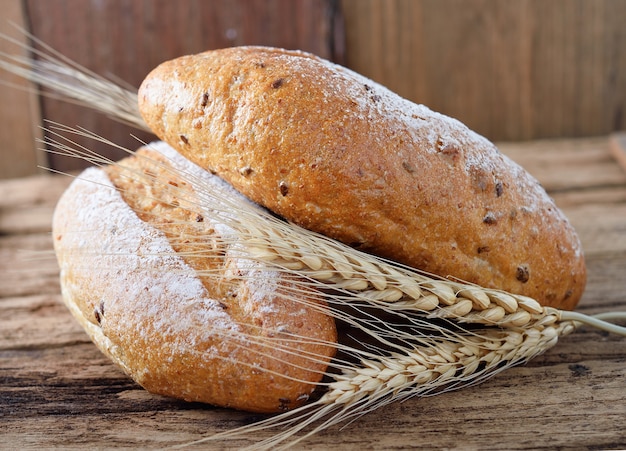 Bread and wheat on the wooden