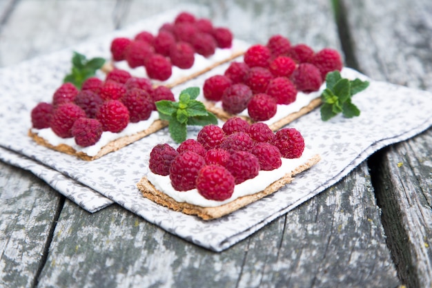 Bread with curd cheese and fresh raspberries.