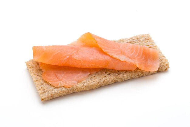 Bread with fresh salmon fillet isolated on white