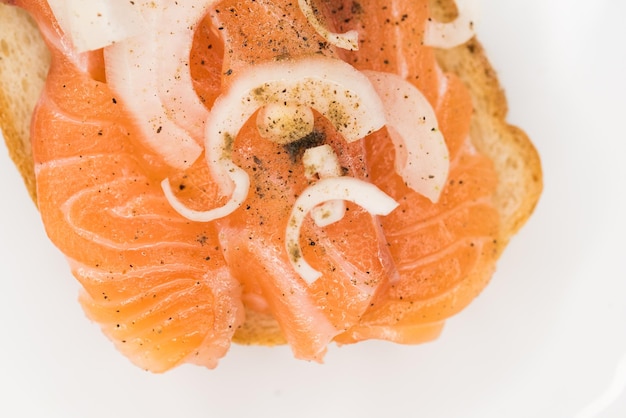 Bread with fresh salted salmon fillet isolated on white background top view