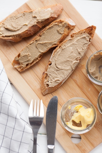Bread with pate and butter on a textile background.