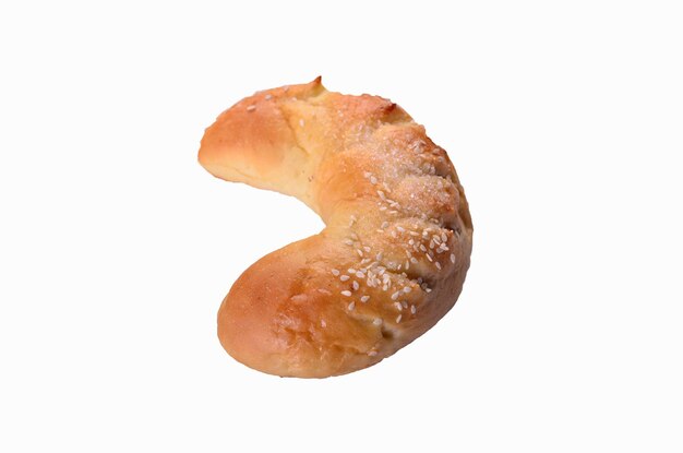 A bread with sesame seeds on it is shown on a white background.