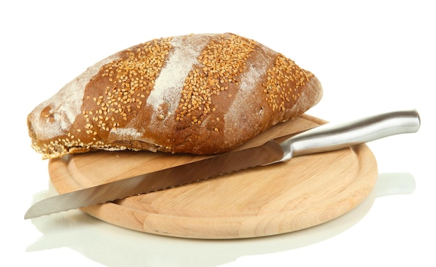 Bread with sesame seeds and knife on wooden board isolated on white