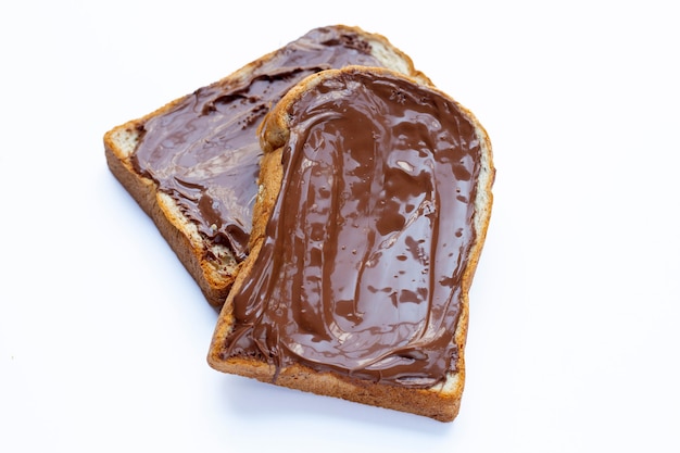 Bread with sweet chocolate hazelnut on white surface.