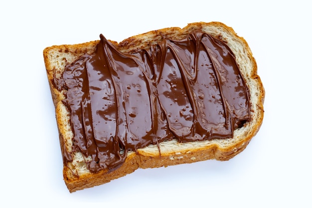 Bread with sweet chocolate hazelnut on white surface.