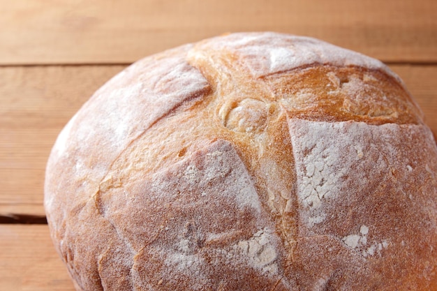 Bread on wooden background Wheat bread from oven on pine boards Copy space