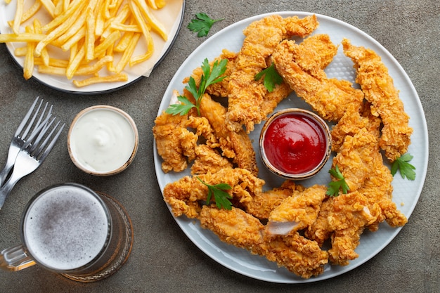 Breaded chicken strips with two kinds of sauces.