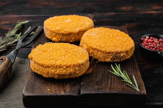 Breaded fish patties set, on old dark  wooden table background