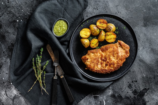 Breaded german weiner schnitzel with potatoes. . 