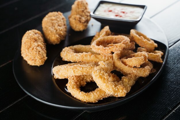 Breaded meat appetizer and onion rings