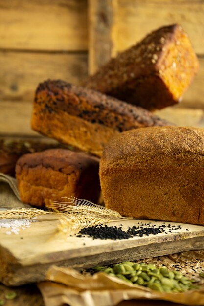 Breads on cutting board, rustic wooden table