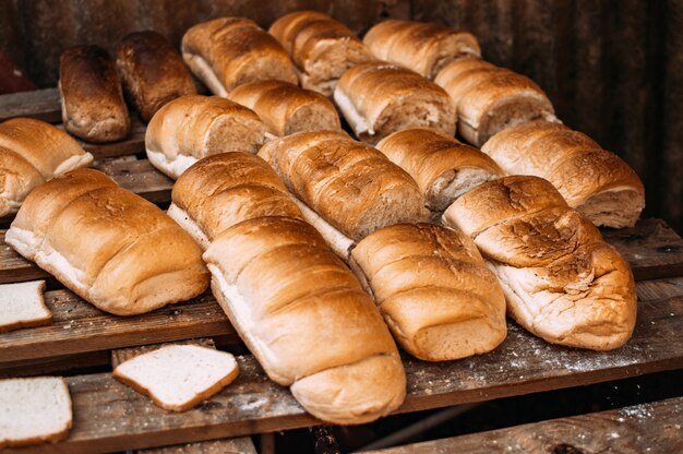 Breads laid down on wooden table.