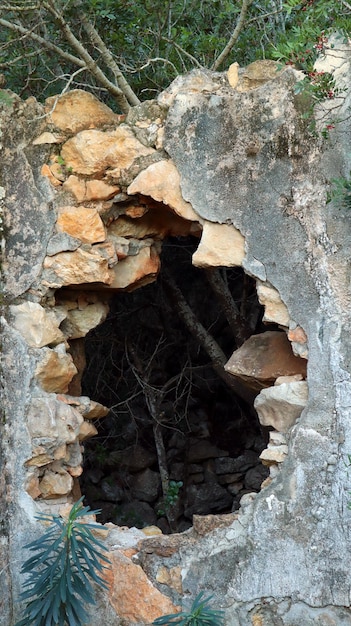 Break, hole in an old stone wall, an old house with a hole in wall, an ancient building