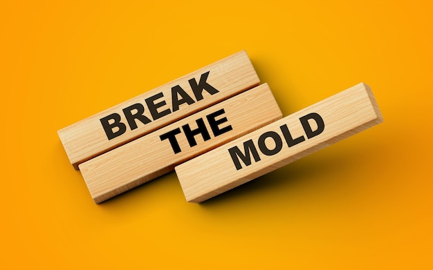 Break the mold text on wooden blocks isolated on yellow orange background 3d illustration