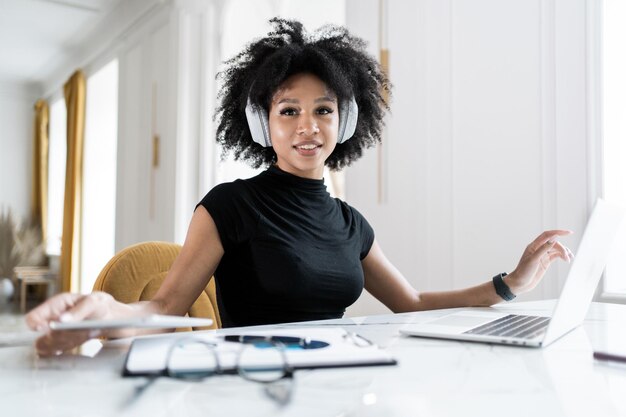 Break a woman with headphones listening to music a secretary\
working in the office