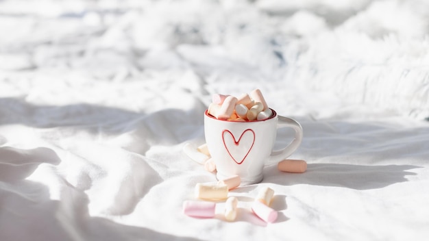 Breakfast in bed for couples pastel flat lay composition with cups coffee and sweet marshmallow. Concept woman's or Valentine's Day.