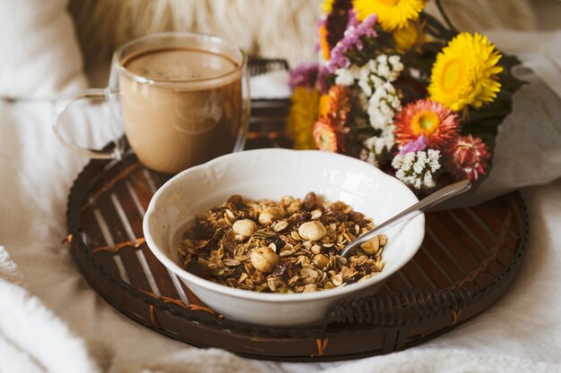 Breakfast in bed with bouquet of flowers