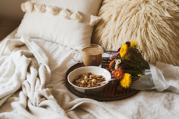 Breakfast in bed with bouquet of flowers