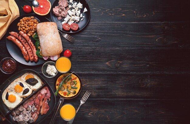 Breakfast on a black wooden table in rustic style