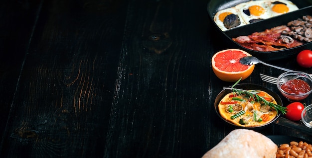 Breakfast on a black wooden table in rustic style