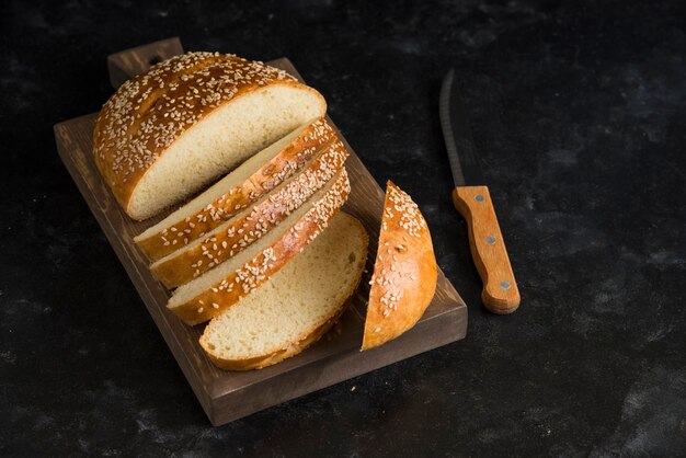 Breakfast bread on cutting board dark background