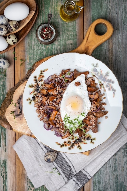 Breakfast Buckwheat porridge with wild mushrooms chanterelles and egg