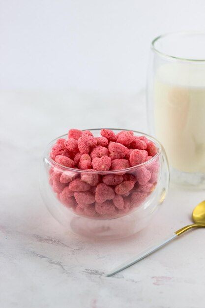 Breakfast cereal with strawberry flavor A bowl of snacks on a white marble table