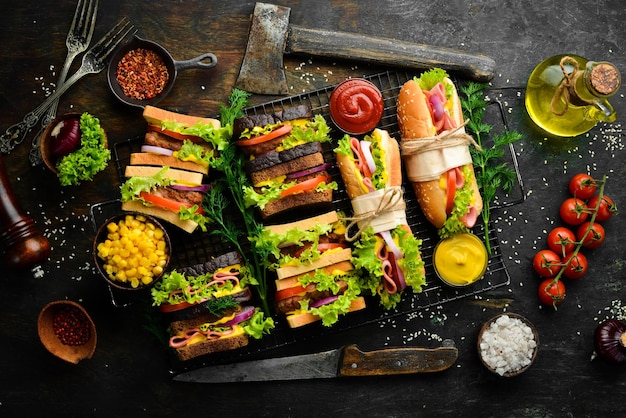 breakfast. classic sandwiches with sausage, cutlet, lettuce, onion, tomatoes and vegetables. rustic style. free copy space.