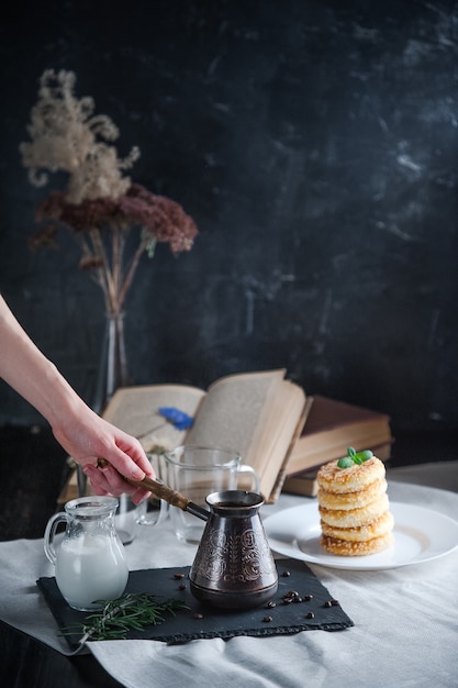 Breakfast. coffee with cream and cheese cakes with sesame