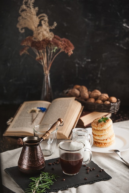 Breakfast. coffee with cream and cheese cakes with sesame