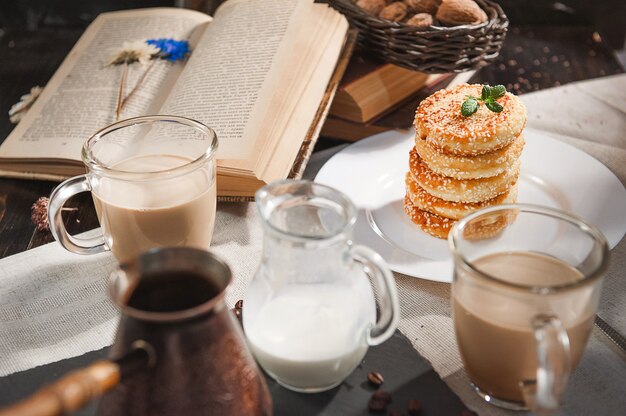 Breakfast. coffee with cream and cheese cakes with sesame