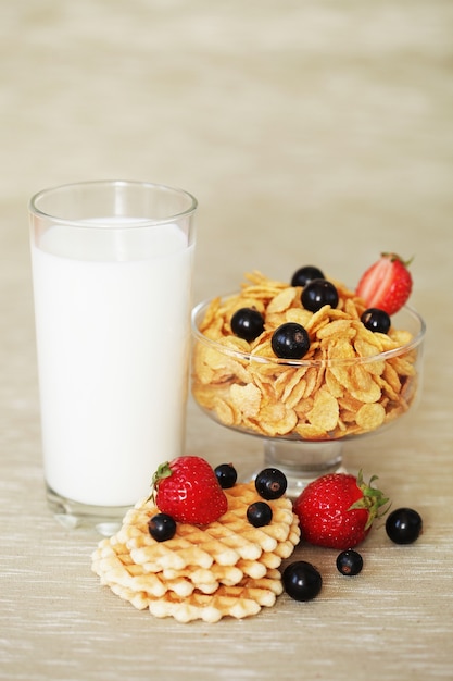 Breakfast - cornflakes with glass of milk. Wafers, black currants and strawberries.