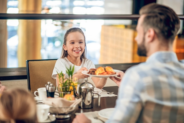 Breakfast. Dad having breakfast with his daughter and looking happy