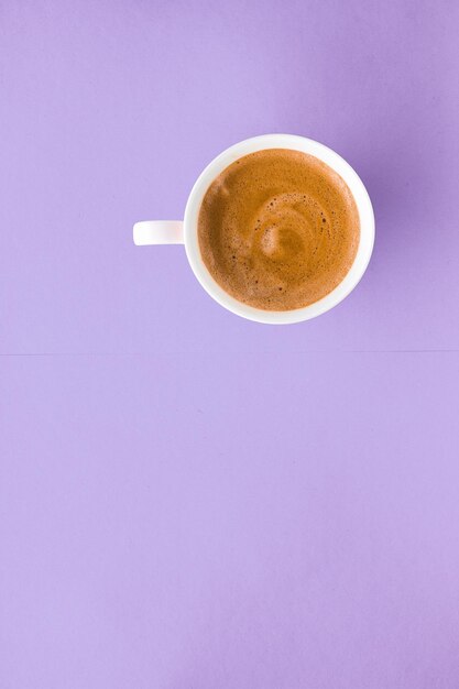 Breakfast drinks and cafe menu concept - coffee cup on purple background top view flatlay