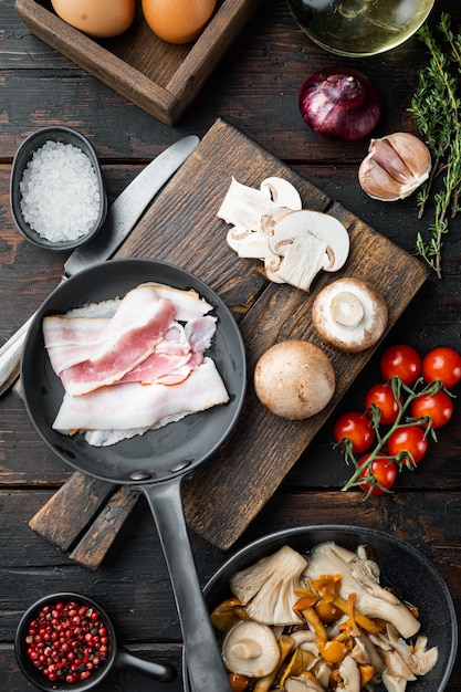 Breakfast egg ingredients mix, on old dark wooden table