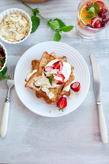 Breakfast of french toast with strawberries and maple syrup