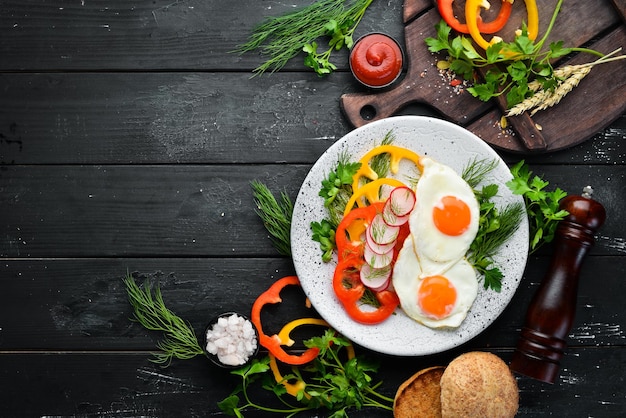 Breakfast. Fried eggs with vegetables. Top view. Free copy space.