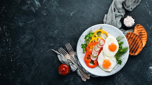 Breakfast Fried eggs with vegetables Top view Free copy space