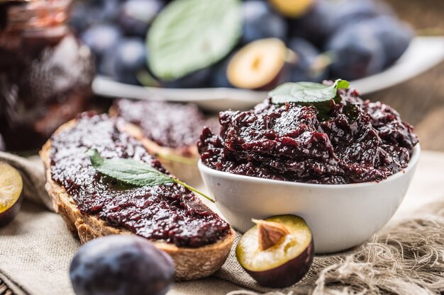 Breakfast from homemade plum jam bread and fresh ripe plums.