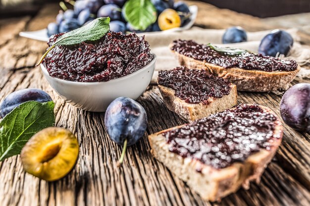 Breakfast from homemade plum jam bread and fresh ripe plums.