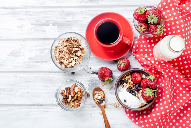 Breakfast granola, strawberry and a cup of coffee