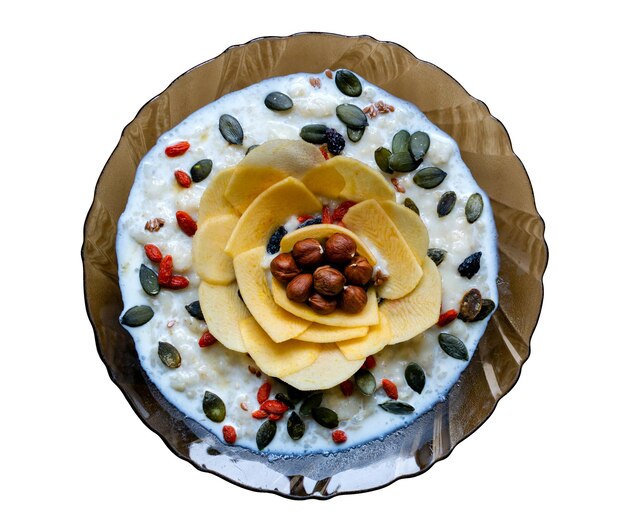 Breakfast healthy food porridge with nuts seeds and dried fruits in a plate